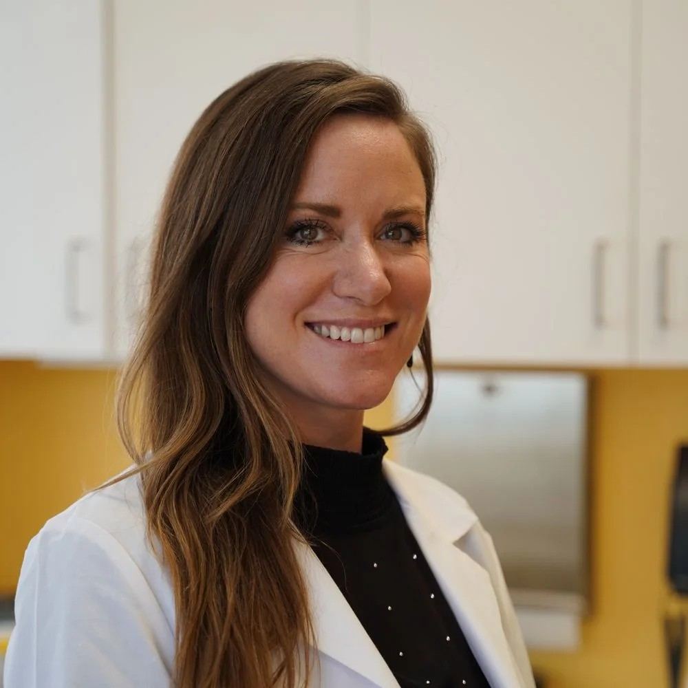 Elena Hart, founder of PeptideScience — portrait in her clinic, white lab coat, shelves of failed serums behind her